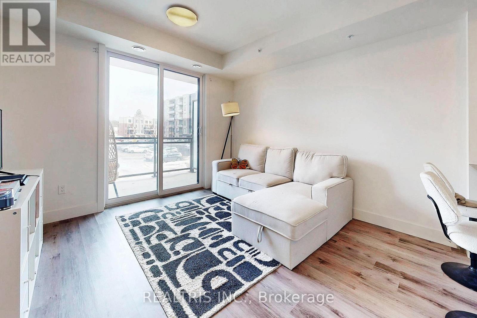 A living room with a white couch and a rug with the word "REALTOR" on it.