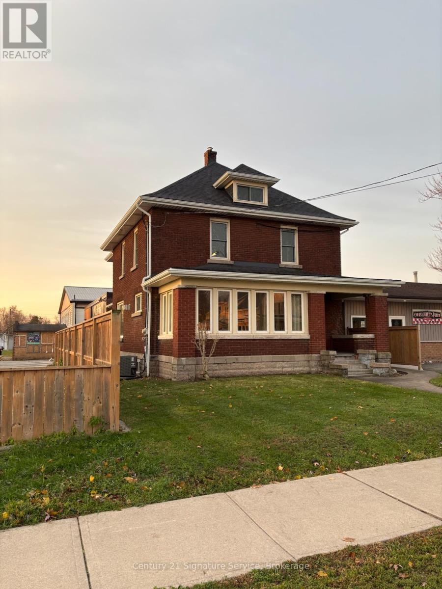 A house with a brown fence in front of it.