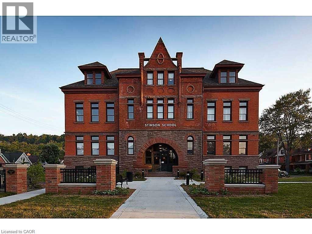A large red brick building with the words "SINGLE SCHOOL" on the front.