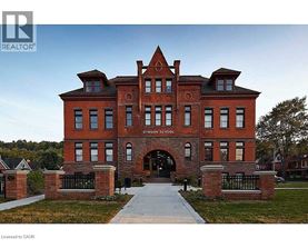 A large red brick building with the words "SINGLE SCHOOL" on the front.
