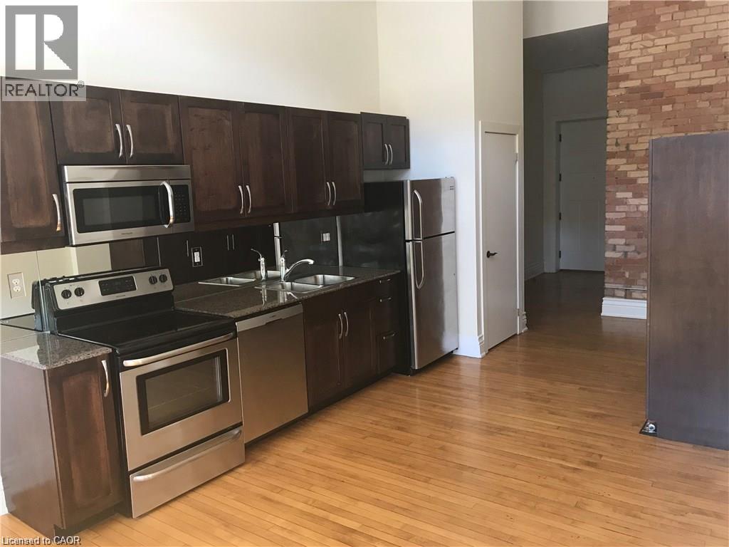 A kitchen with wooden cabinets and stainless steel appliances.