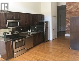 A kitchen with wooden cabinets and stainless steel appliances.