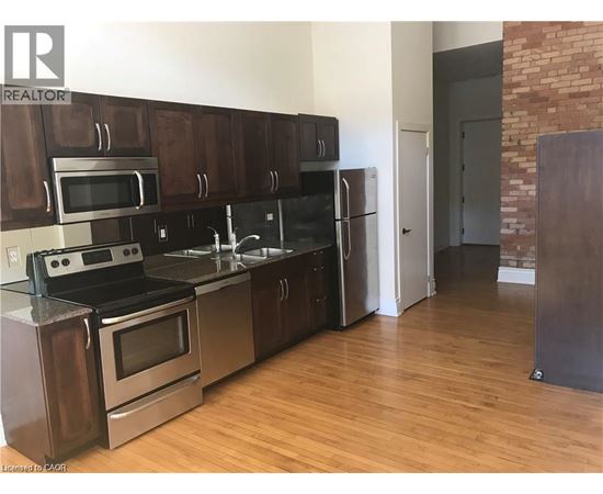 A kitchen with wooden cabinets and stainless steel appliances.