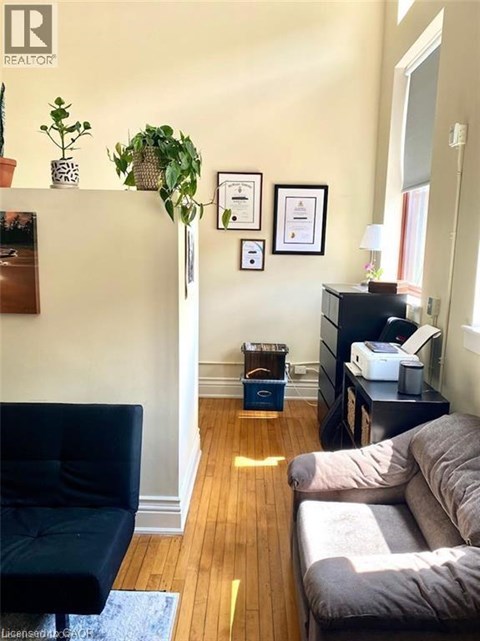 A living room with a black chair and a grey couch.