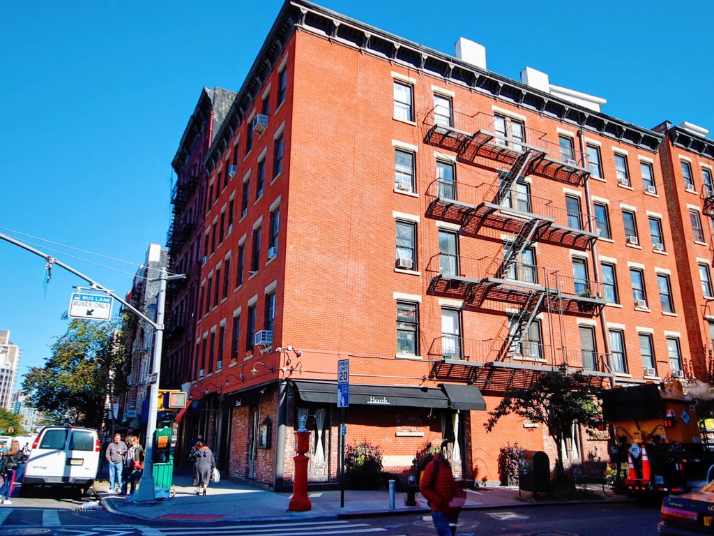 a red brick building on the corner of a city street