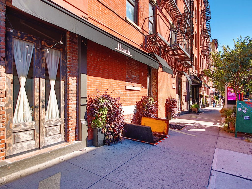a piece of furniture sitting on the sidewalk in front of a building