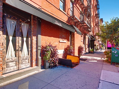 a piece of furniture sitting on the sidewalk in front of a building