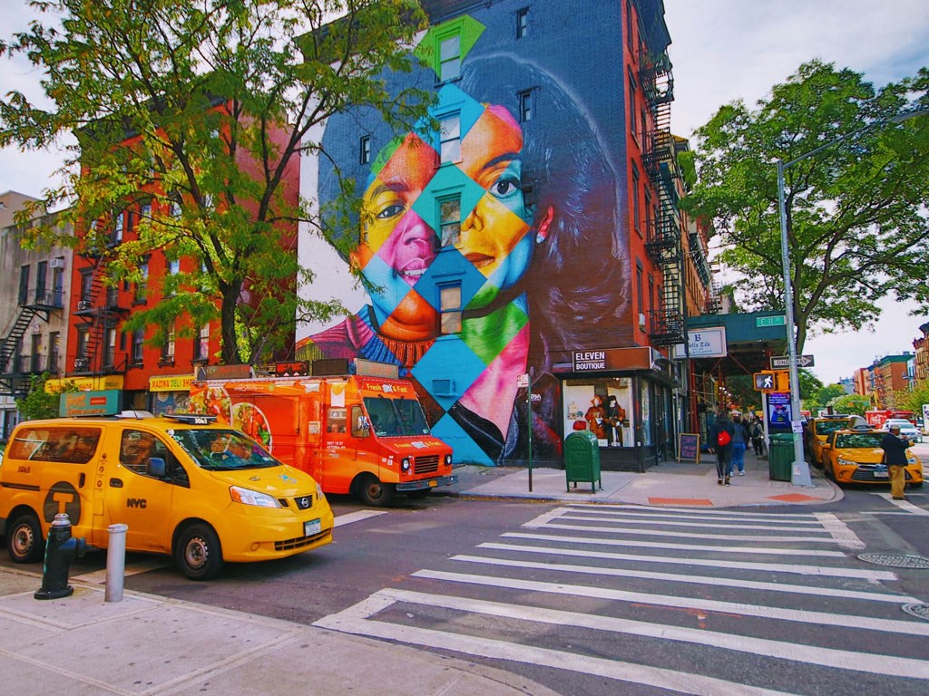 a mural on the side of a building on a city street