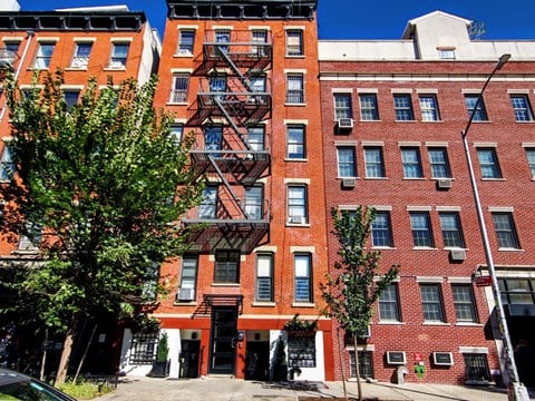a red brick apartment building with a fire escape