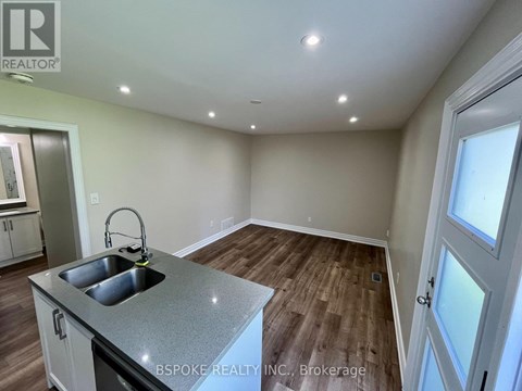 A kitchen with a sink and a window.
