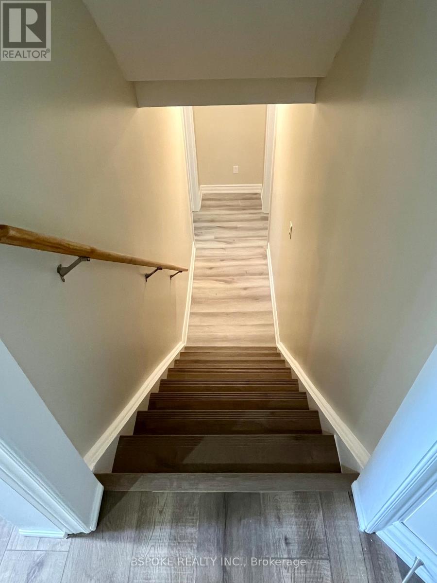 A staircase with wooden steps and a light-colored wall.