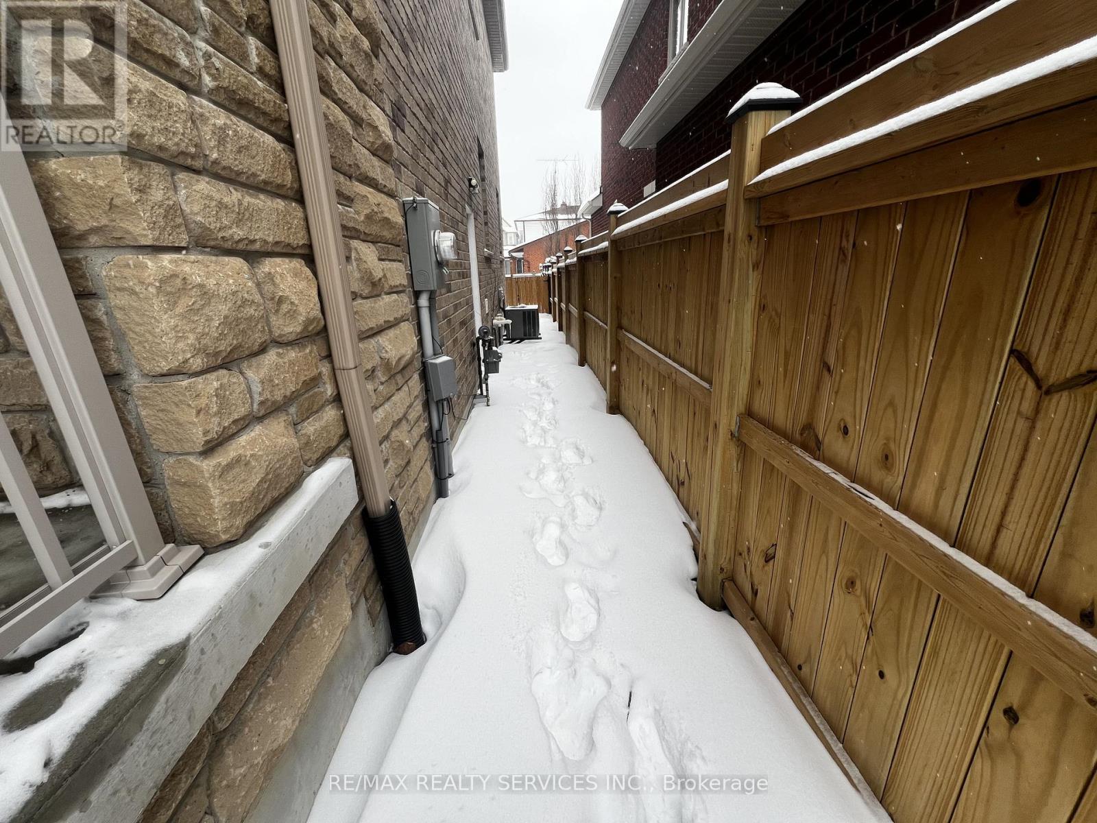 A snow-covered walkway between two buildings.