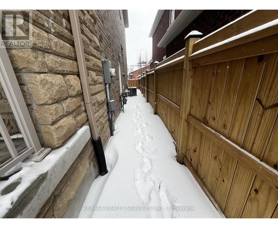 A snow-covered walkway between two buildings.