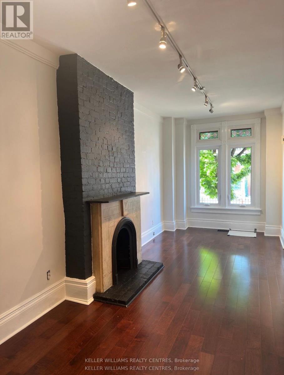 A room with a fireplace and a window.