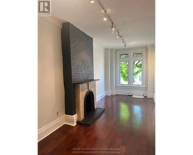 A room with a fireplace and a window.