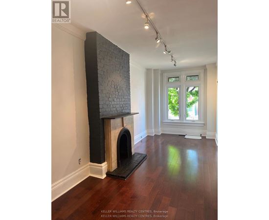 A room with a fireplace and a window.