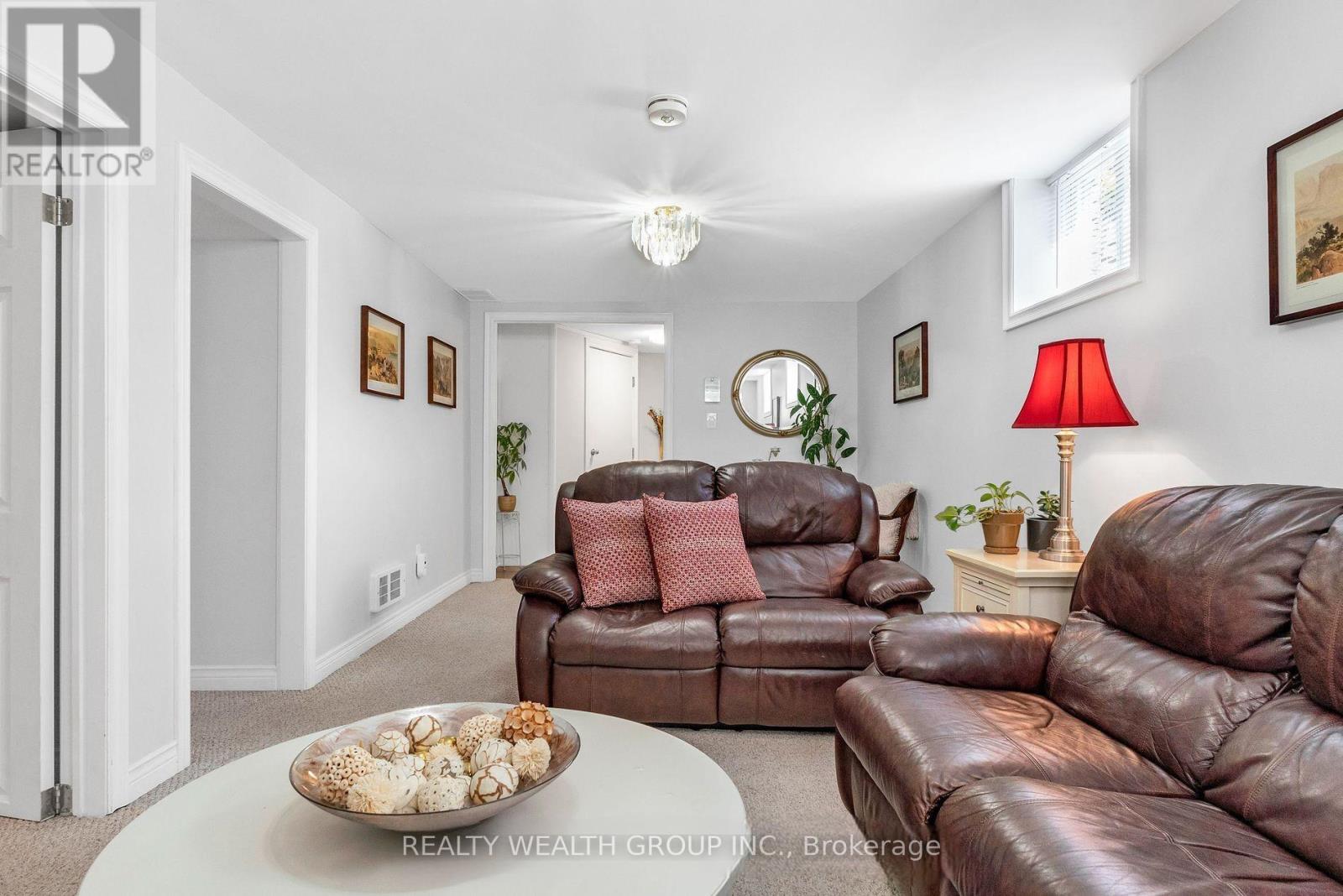 A living room with brown leather couches and a white coffee table.