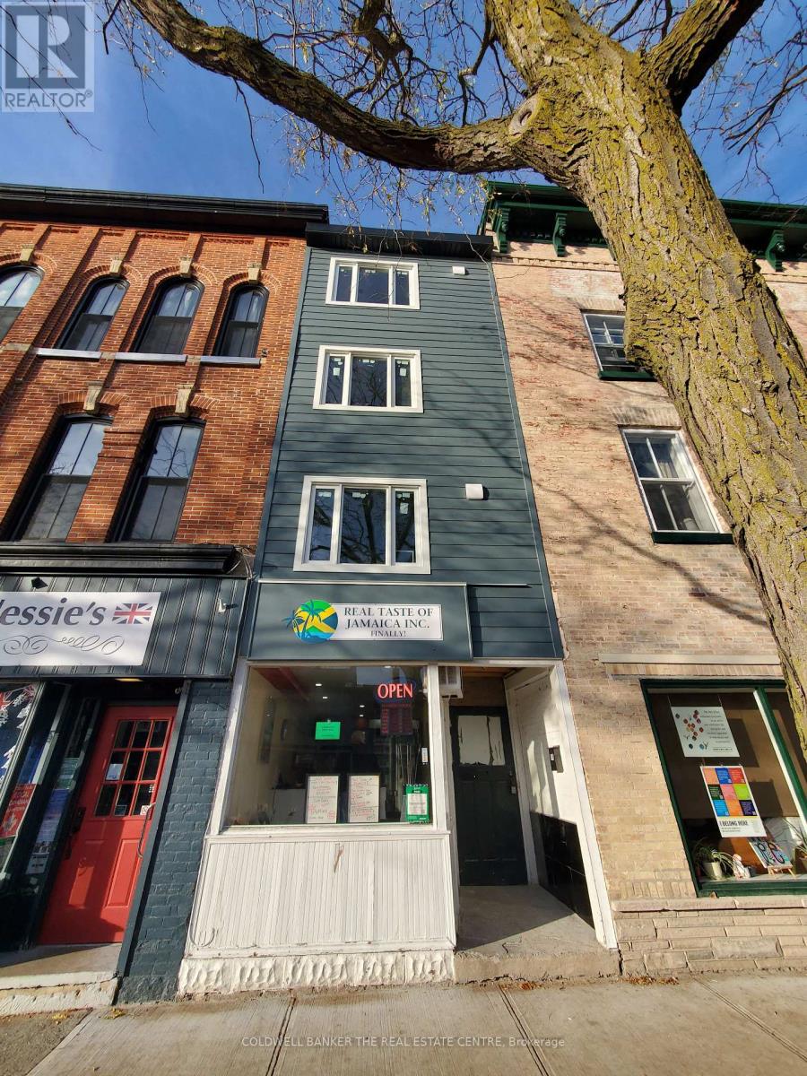 A building with a Real Estate sign on the front.