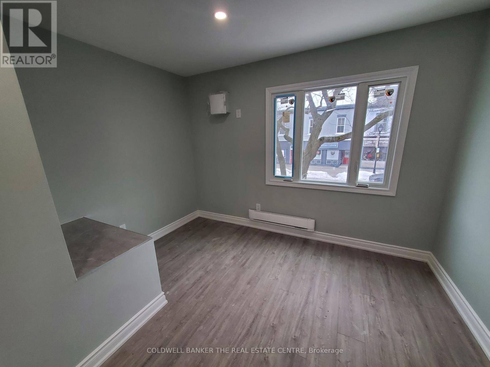 A room with a window and a bench.