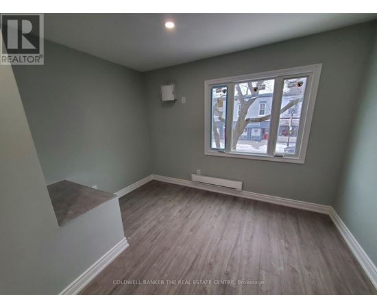 A room with a window and a bench.