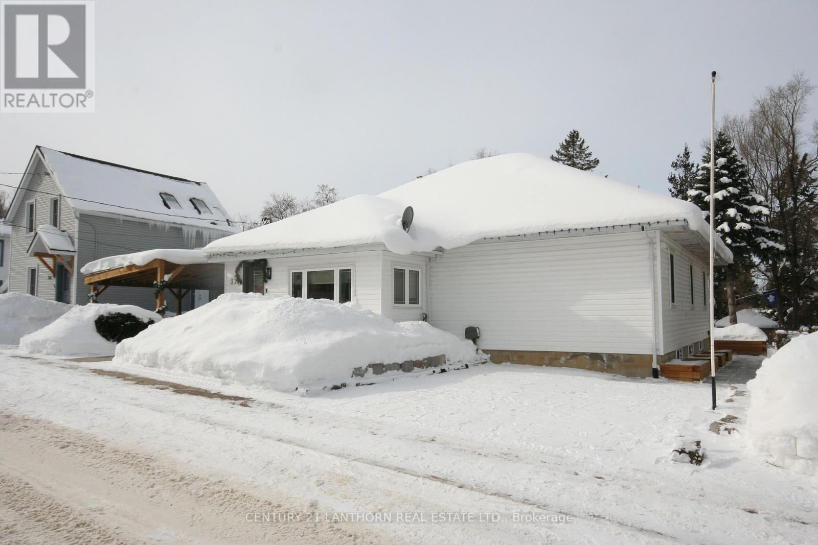 A house with a snow-covered roof and driveway.