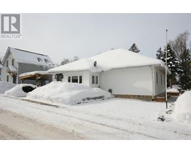 A house with a snow-covered roof and driveway.