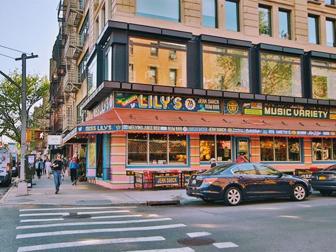 a car parked in front of a music store on a city street