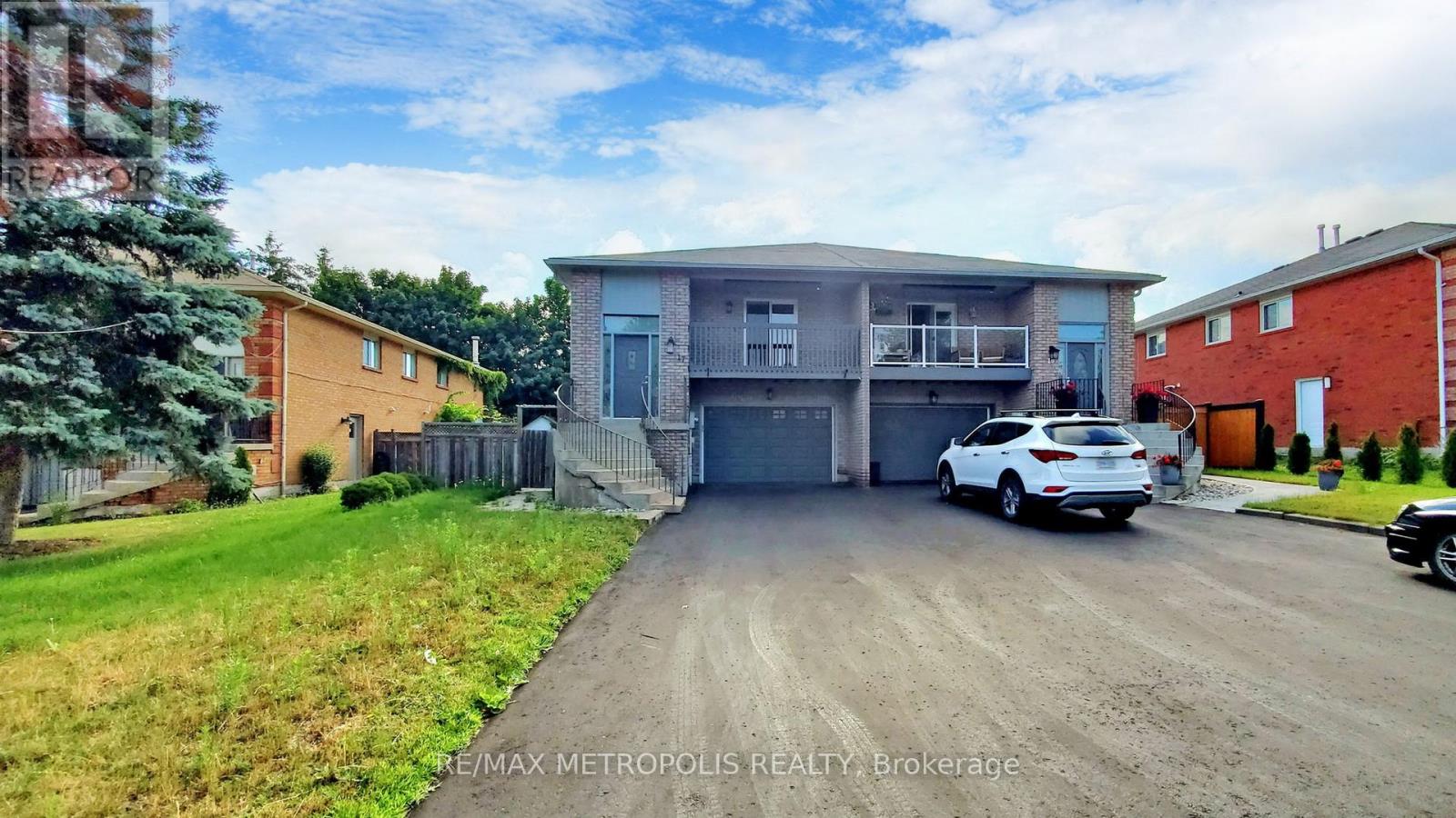 A car is parked in front of a two-story house with a garage.