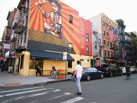 a man crossing a street in front of a building