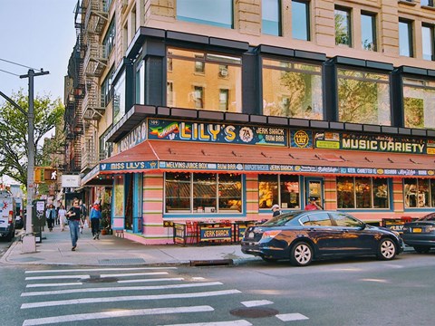 a car parked in front of a music store on a city street