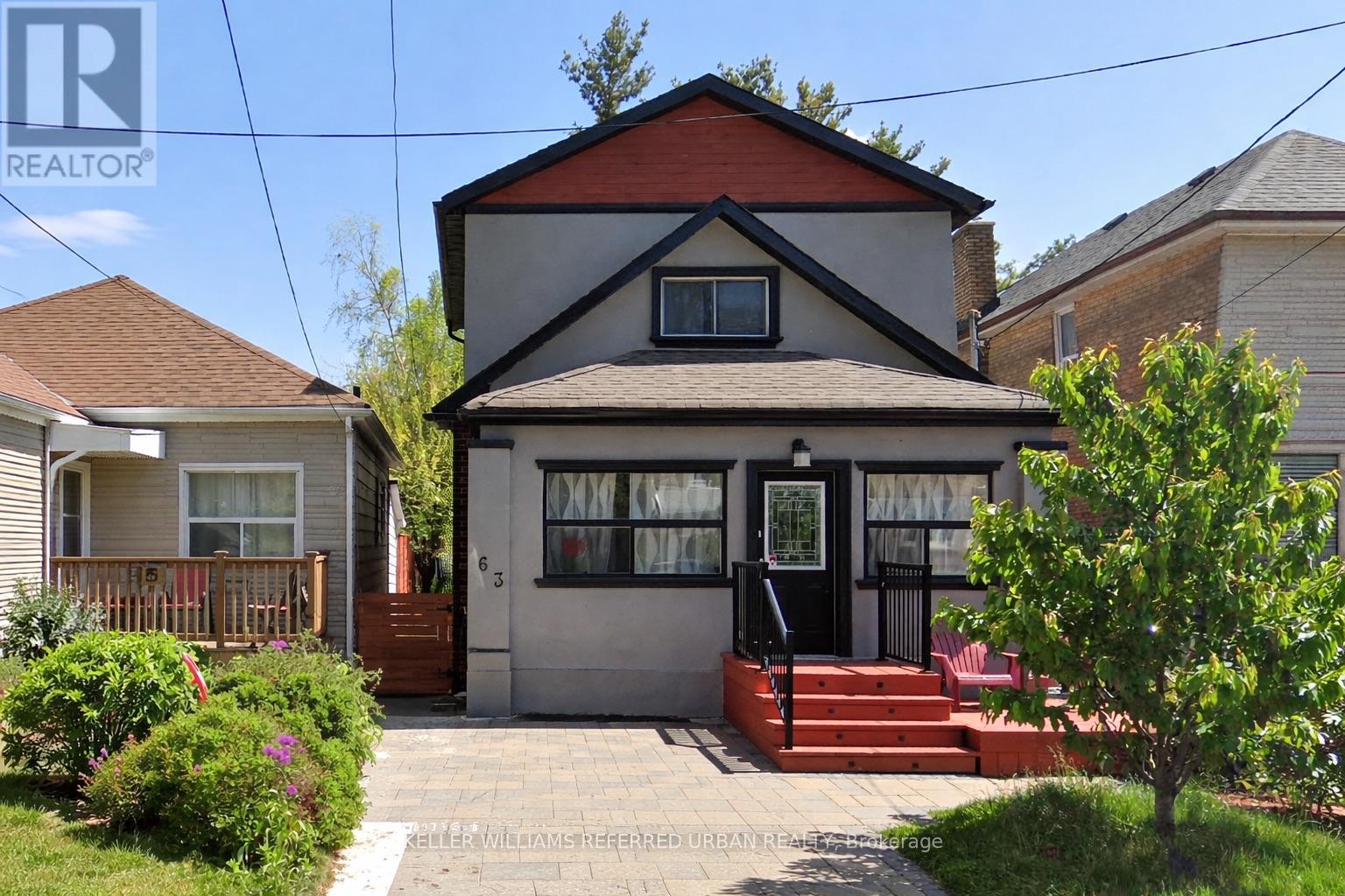 A house with a black door and a red staircase.