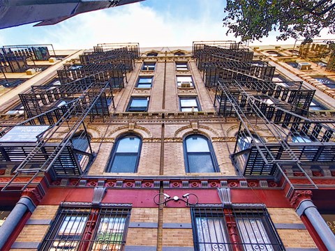 a tall building with fire escapes on the side of it