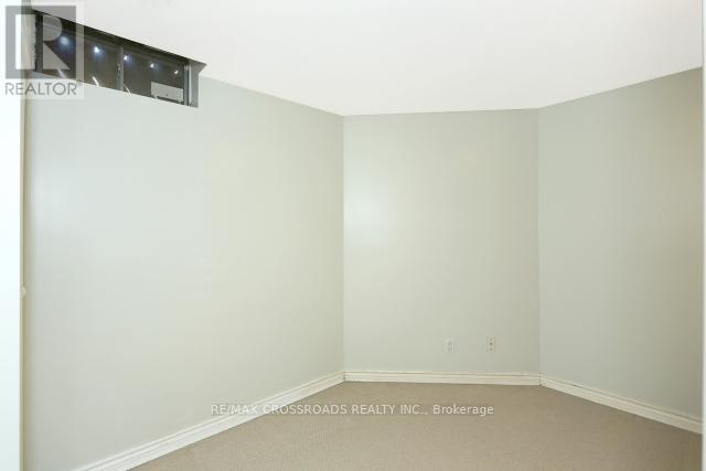 A room with a white wall and a carpeted floor.