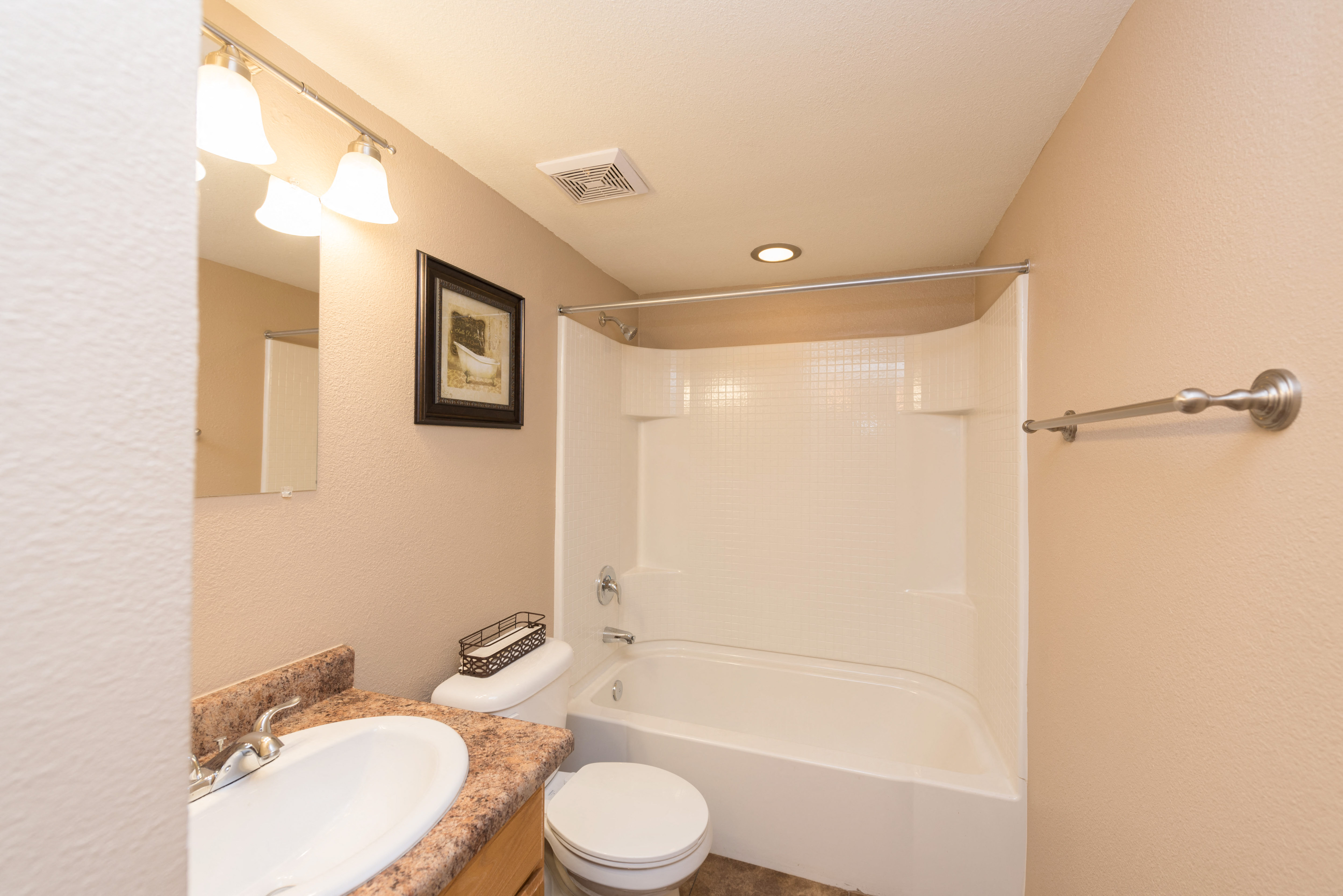 a bathroom with a shower toilet and sink and a tub