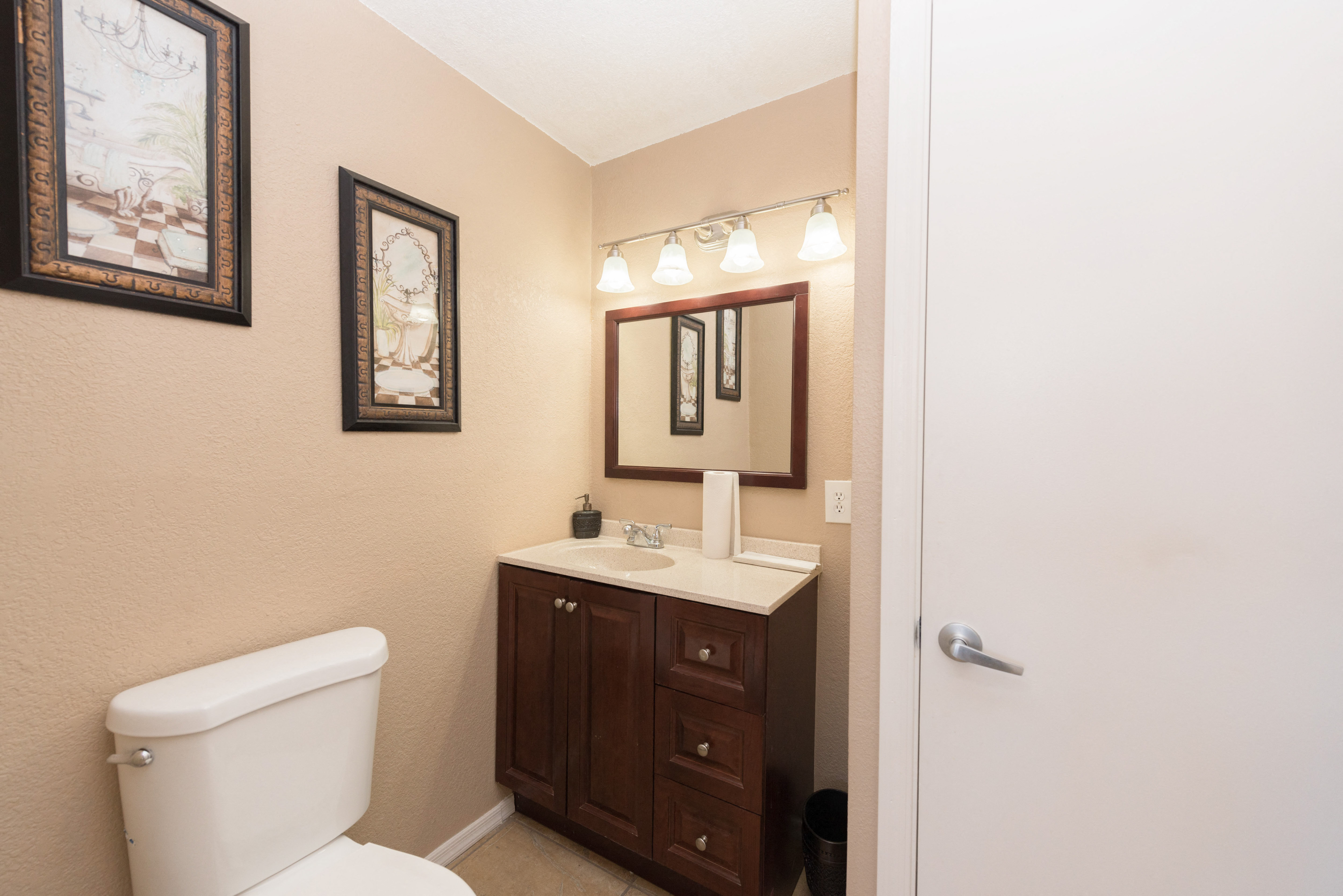a bathroom with a toilet and a sink and a mirror