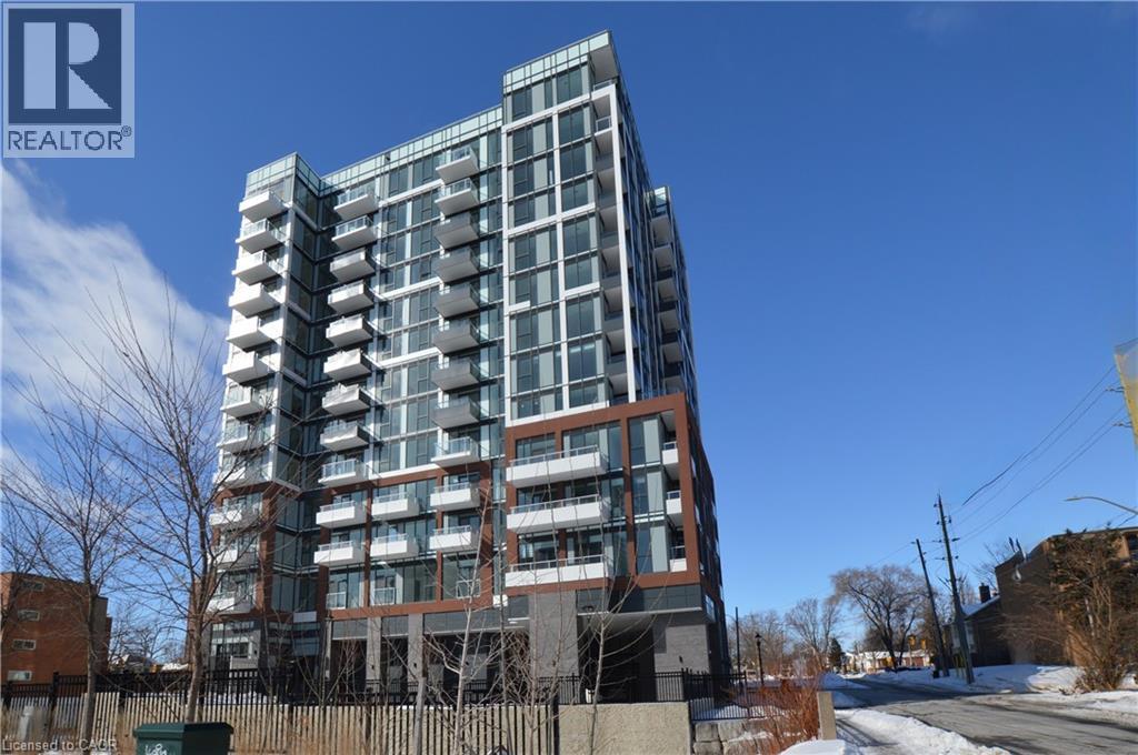 A tall residential building with many windows and balconies.