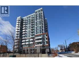 A tall residential building with many windows and balconies.