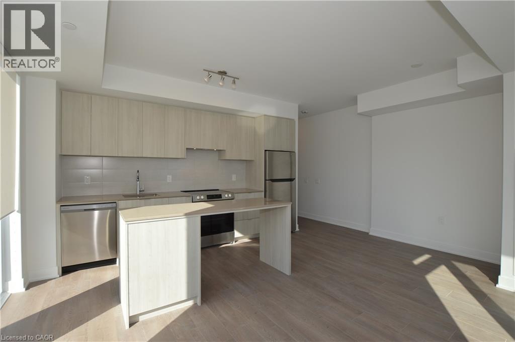 A well-lit kitchen with wooden cabinets and a stainless steel dishwasher.