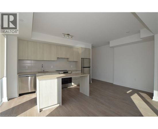 A well-lit kitchen with wooden cabinets and a stainless steel dishwasher.