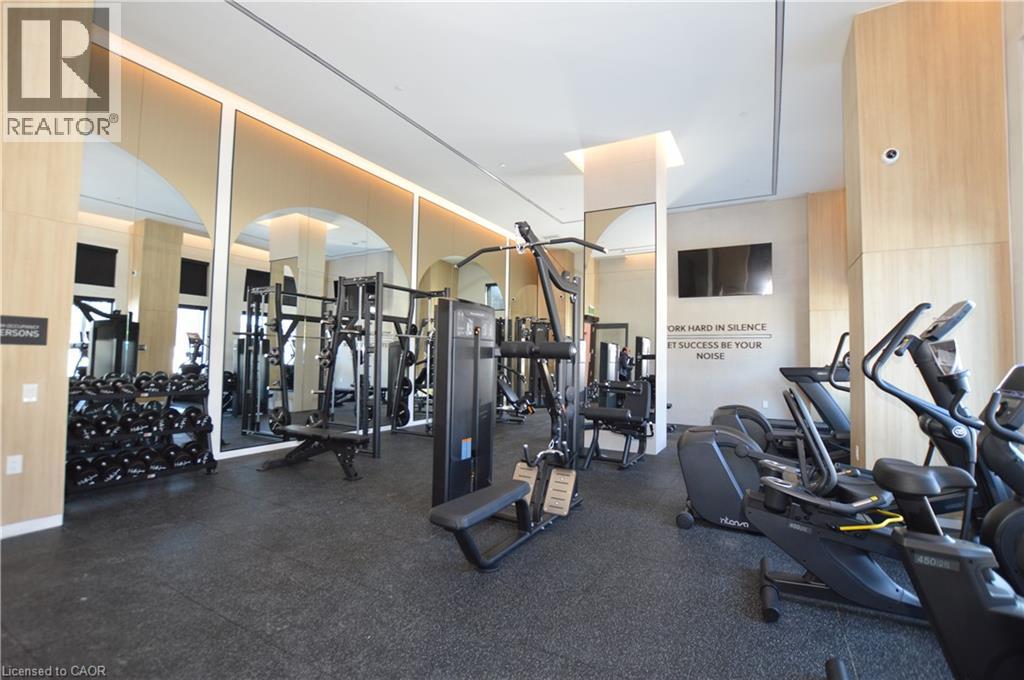 A gym with a variety of equipment including treadmills, weights, and exercise machines.