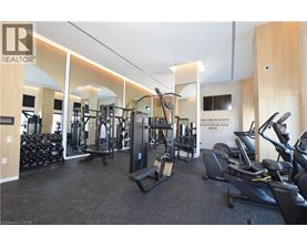 A gym with a variety of equipment including treadmills, weights, and exercise machines.