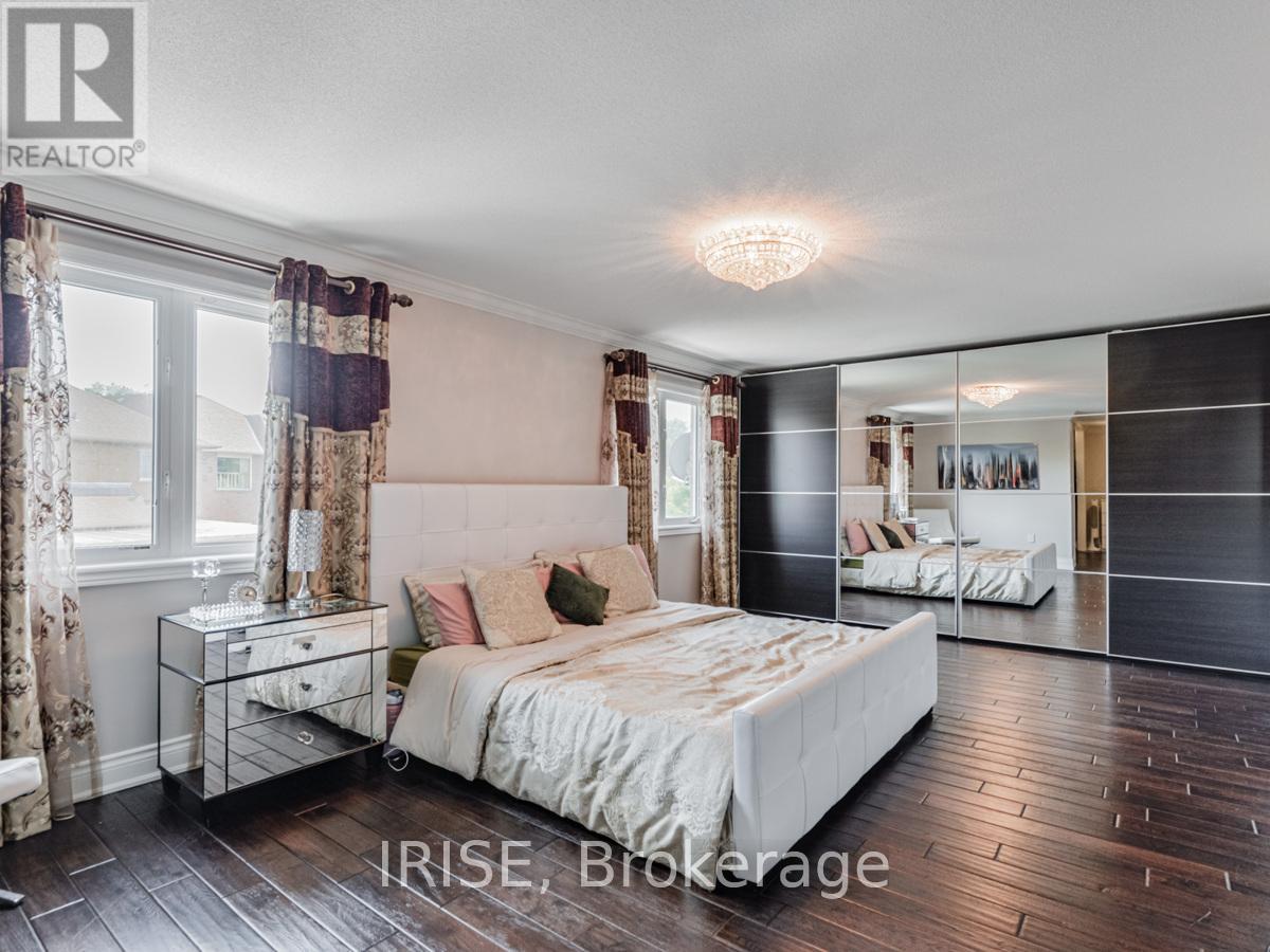 A bedroom with a large bed and a mirrored wall.