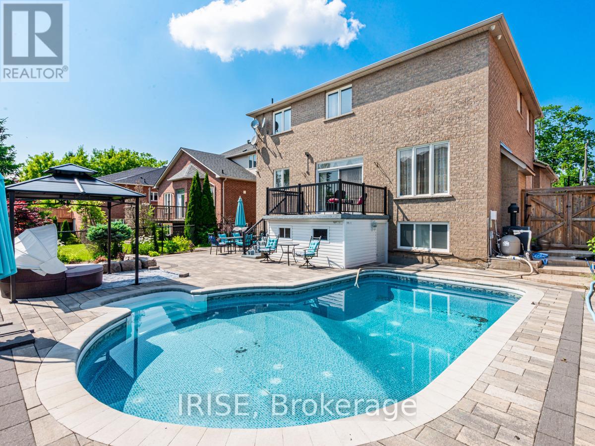 A swimming pool in a backyard with a house in the background.