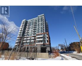 A tall residential building with a fence in front of it.