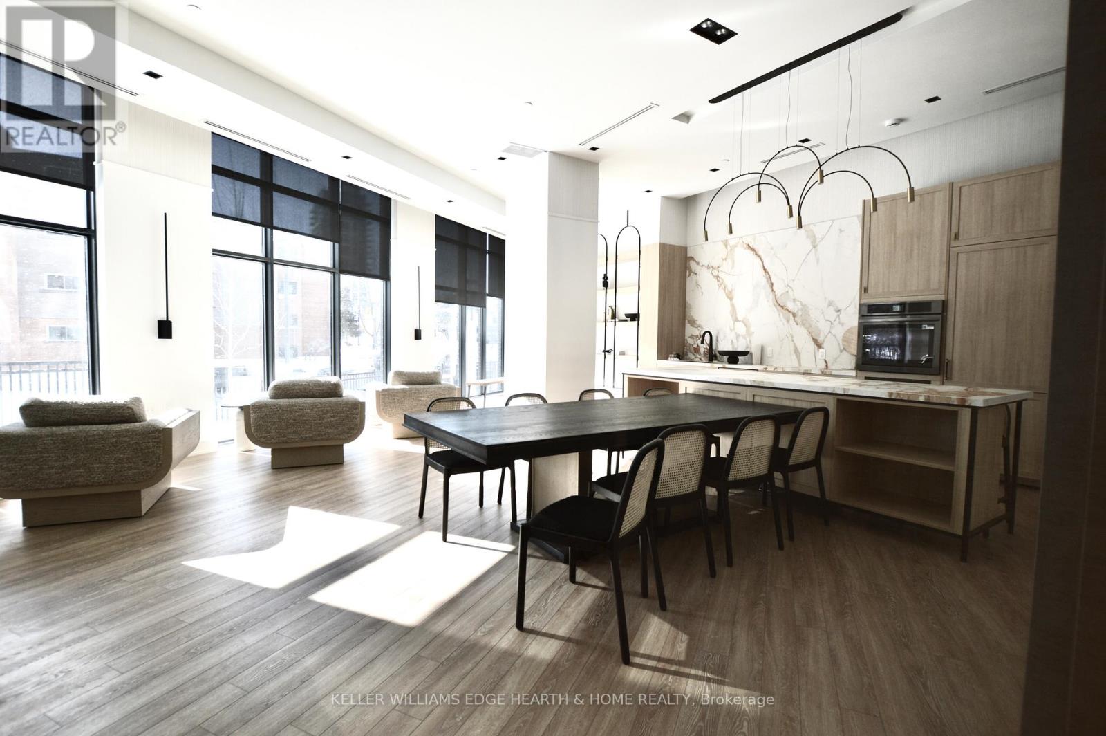 A modern dining room with a large table and chairs.