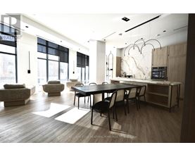 A modern dining room with a large table and chairs.