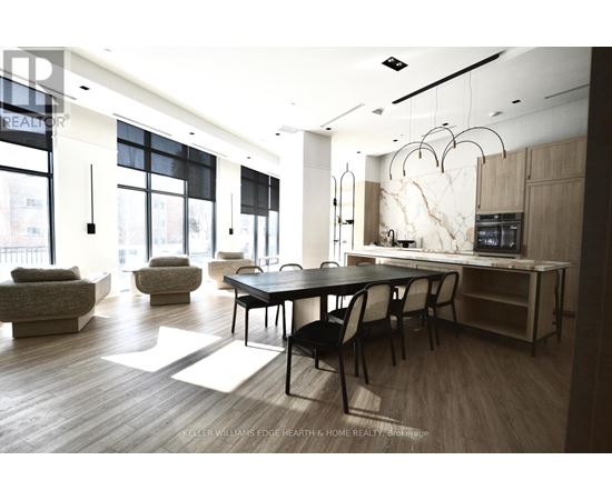 A modern dining room with a large table and chairs.