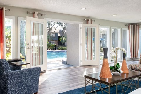 a living room with a table and chairs and a pool