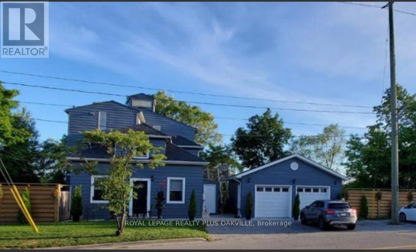 A blue house with a white garage door is for sale.