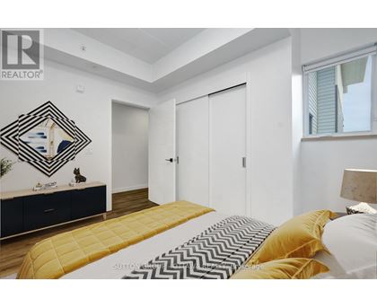 A bedroom with a bed, dresser, and mirror.